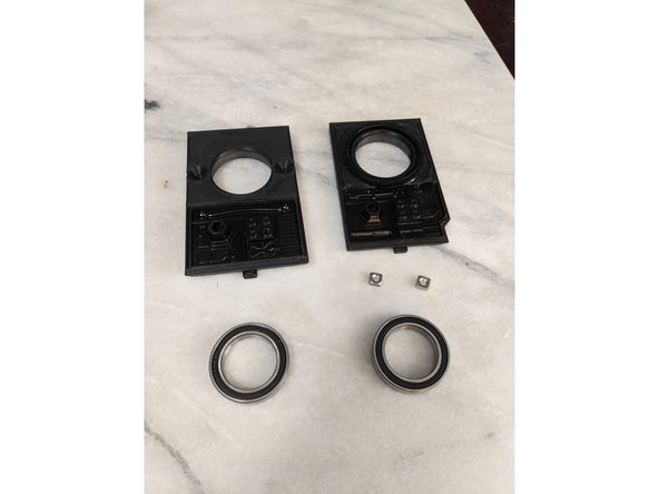 Here you will use FrontFrameInsert and RearFrameInsert prints or the insert assemblies made in the previous step.  You will also use 2x M4 Square Nuts and 2x 6805 Bearings as shown in Pic 1.