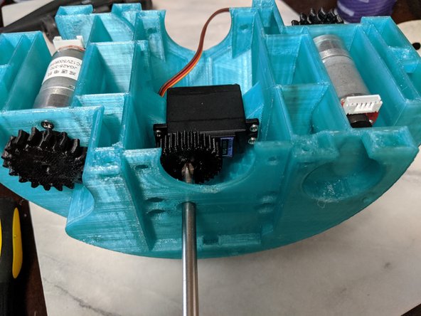 Attach the servo to the MainFrame using the servo screws as shown in Pic 2.  The holes in the side of the MainFrame are for a screwdriver to go through to tighten the screws.