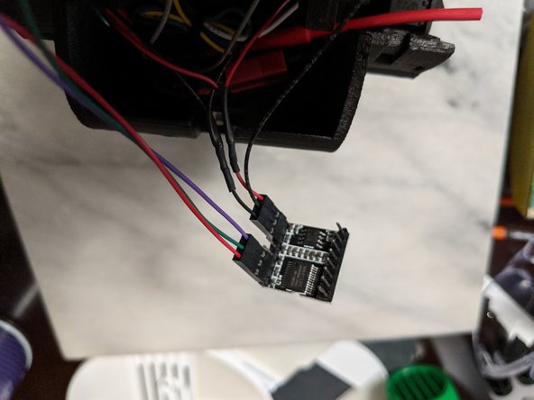 Start with the ground wire that  you did not put in a housing.  This goes in the center pin of the housing the speaker wires went in earlier as shown in Pic 1.