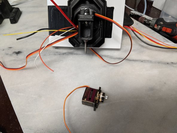 Here we will use another MG90S servo and the two mounting screws that come with the servo.