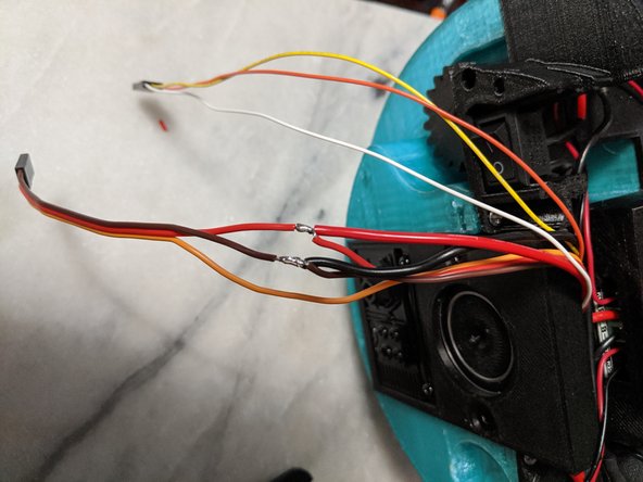 Carefully strip the power wires of the center servo.  On my servo these are the red and brown wires.  The third wire is the signal wire and it is typically yellow.  Separate the wires and strip them as shown in Pic 1.  I used an xacto knife to strip a section of the wire coating off.
