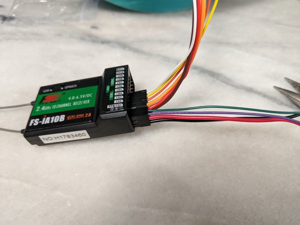 You can plug the harness into the receiver into channels 1 and 2 as shown in Pic 1.  This will also connect the positive and ground wires to the receiver in one of the channels as well.  These wires will power the arduino.