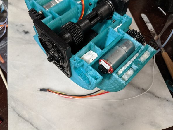 You will now take that section of wires and feed them through the center of the MainBar and out the hole located in the center of it.