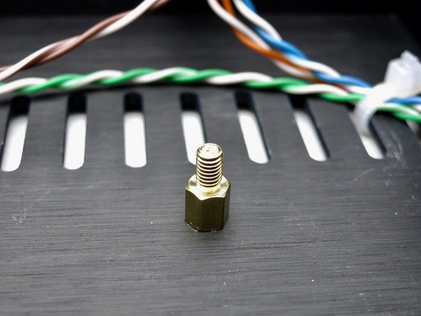 The standoffs attach to the inside of the bottom panel.