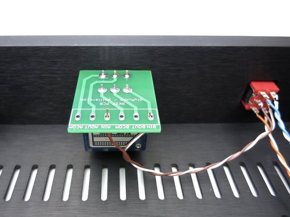 Photo 3 - Grounds are connected to the COM pads and go directly to the input RCAs, not connecting to the switch. Solid green is right, white/green left.