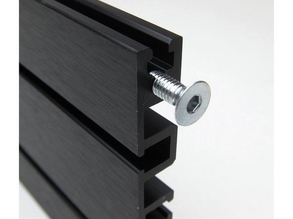 Back panel attaches with screws into the extrusions.