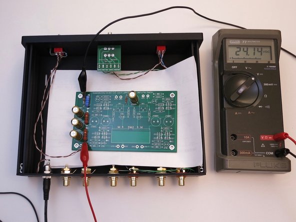 Rest the PCB on a piece of paper to keep it from touching the metal chassis.