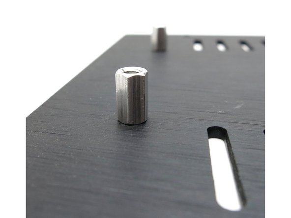 Attach the standoffs to the top plate with the black countersunk screws.