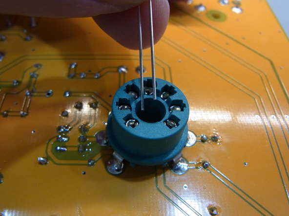 Photo 2 - solder the LED into the board only after the socket is installed.  Make sure the LED is not higher than the socket.  Note that the short leg of the LED is on the side with the black dot.