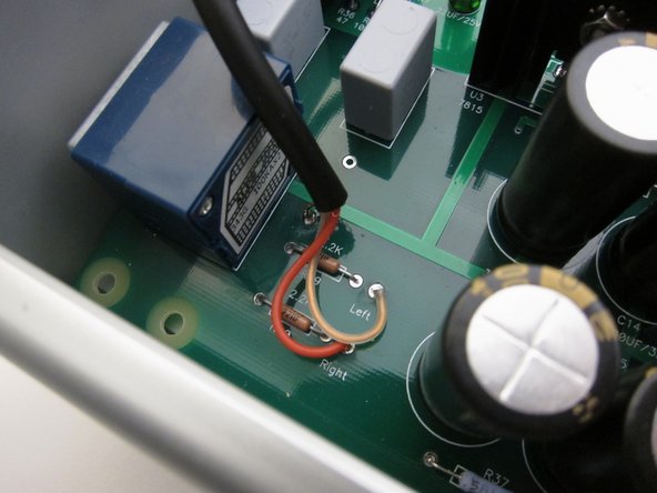 First image: Input at RCA jacks.      The capacitor is a 0.1uF film cap of 50v or better rating. connect from the ground tabs of the RCA jacks to the safety earth at the chassis.