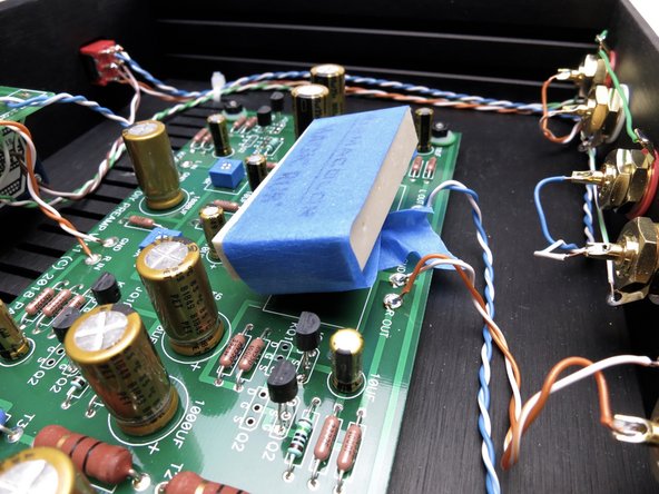 I tried a number of different solutions and the best results were to take a white latex pencil eraser to the to top of the glass, and then seal up the vent holes in the chassis. Newer chassis will not have vent holes.