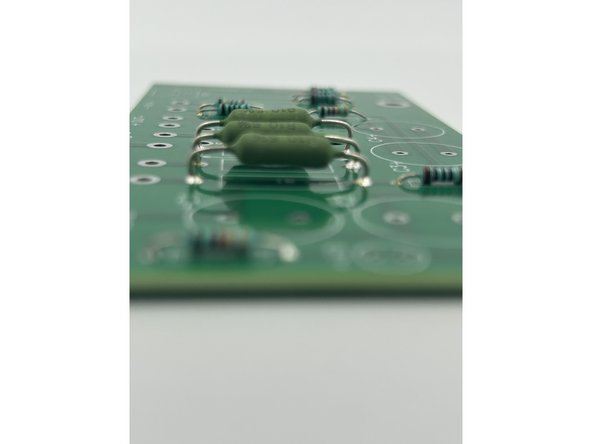 Use a coin (or anything a few mm tall) to aid in leaving a bit of space between the large resistors and the PCB.