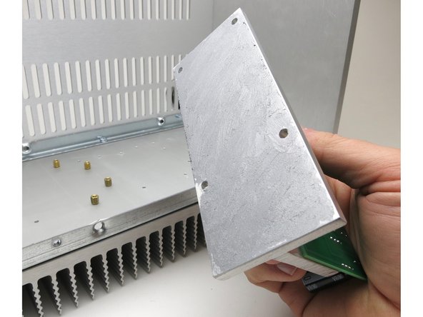 This interface does not need to be electrically isolated.  The thermal goop is electrically conductive, hence the metallic color.  Be careful that you do not get it on your PCBs or other surfaces.