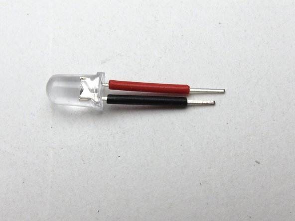 Your kit includes 4 LEDs. Some batches of ACA kits have clear looking LEDs, of which 2 are red and 2 are blue. If this is the case, you will need to test which is which.