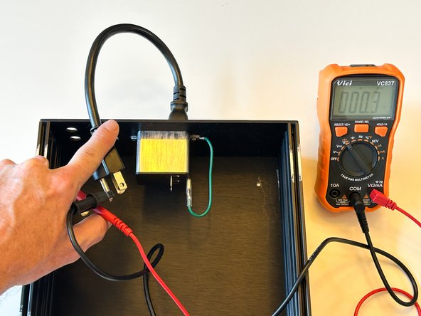 With your DMM set to resistance / continuity.  Measure the resistance from your mains earth to the bare metal on each panel.  If it is more than a fraction of an Ohm, STOP!