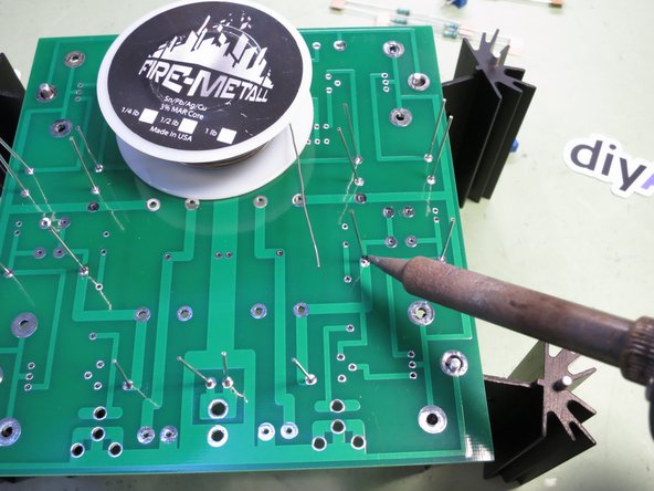 Face them so the heavier brown stripe is on the right. (Or bottom, for the three resistors that point up.)