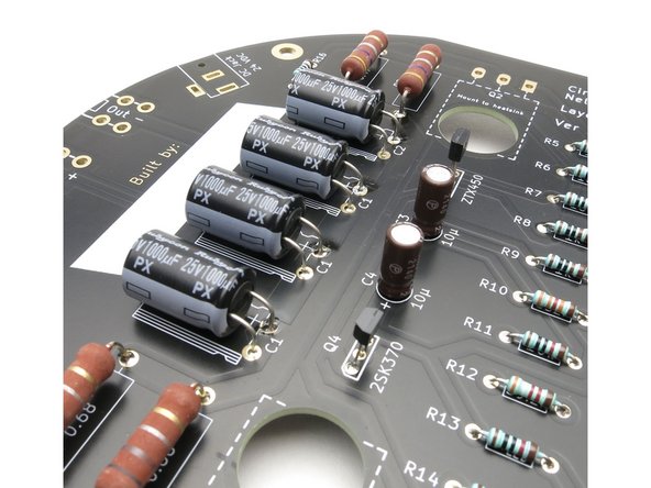 Hold the capacitor as shown, with the negative marking towards you, and bend leads down 90deg.