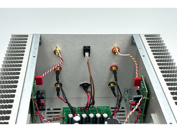 Install the back panel.  Connect the binding posts.  Connect the switch.  Install the power jack.