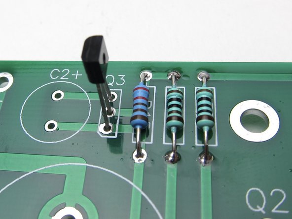 Place Q3. ZTX450  Like the other small transistor the flat of the transistor package matches the flat of the silkscreen.