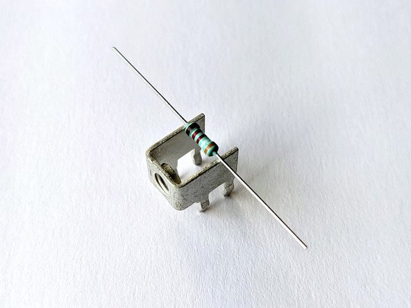 The solder terminals that will be used for the speaker posts will be used as a tool to bend the leads of the small resistors.
