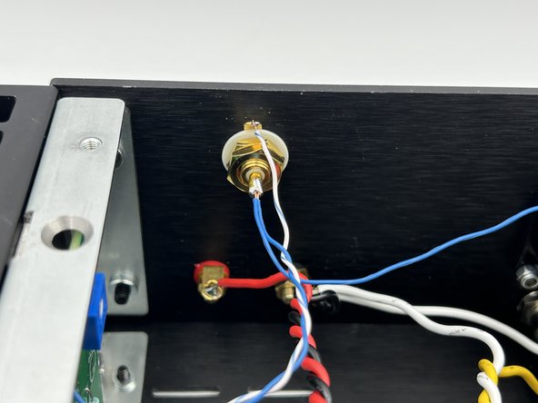 Solder the solid-color input wiring from the PCB (IN +) along with the solid color wire from the center row of the switch to the center post (solder cup) of the RCA jack.