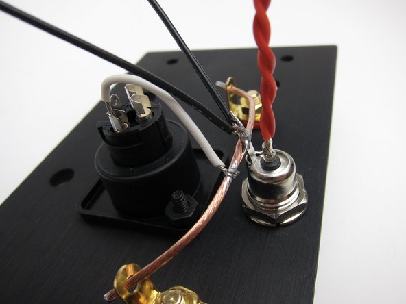 Make a twisted pair from red and attach to the center pin of the barrel connector. This will reach to the front panel switch.