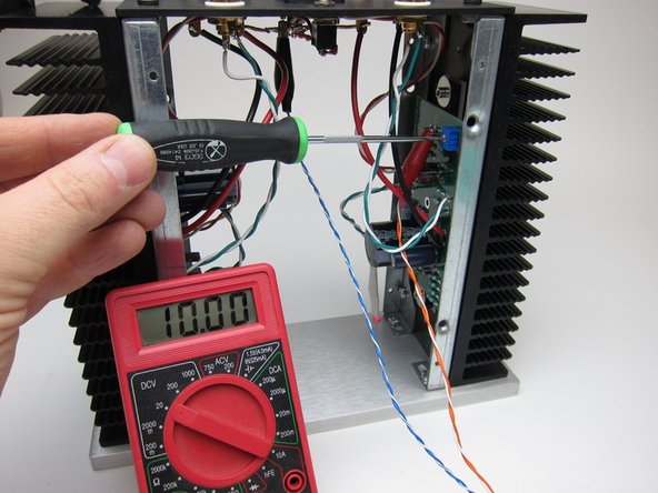 If using 19v PSU Adjust the pot in small steps to get 10v. A few tenths off in either direction is nothing to worry about. If you are using the 24V power supply, adjust the pot to get 12V.