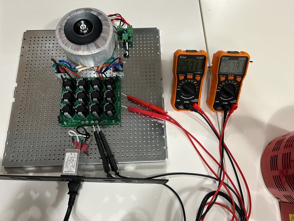 Ensure you can see both DMMs.  Immediately power off the circuit if you smell smoke, see sparks, if the DBT bulb continues to glow brightly after initial power up, or if there is any indication that things are not working properly.
