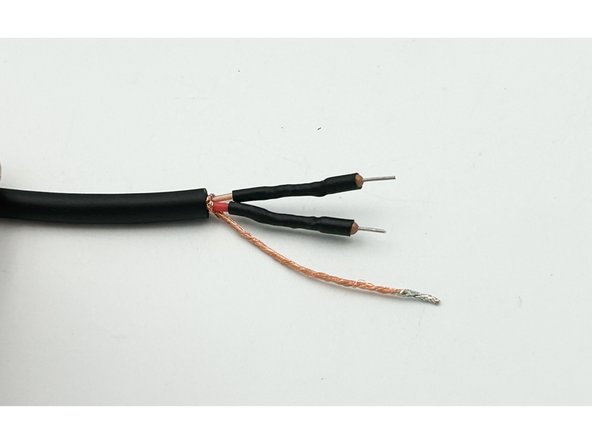 Wind the red (or clear) conductor around the leg of a 47R resistor keeping the winding close to the body of the resistor.  5 or 6 winds is fine.  The goal is a solid, but short, connection.  Solder the wire to the resistor.  Trim the remaining wire and the remaining resistor lead.  Trim the other end of the resistor leaving about 5mm.