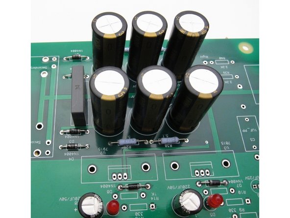 Note that the big caps are polarized, and need to be on the PCB in the right direction or they will blow up. The + is noted on the PCB, and the + also has a square pad. + is indicated on the capacitor by the long lead, in addition, - is shown on the cap’s insulation.
