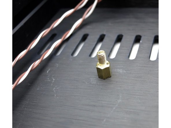 The standoffs attach to the inside of the bottom panel.