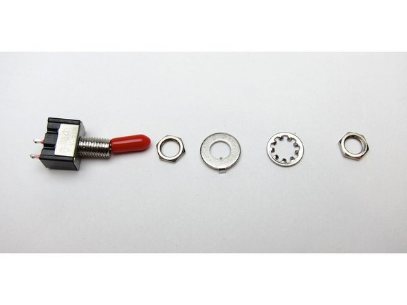 First image: Note that the big washer has a key to fit in the switch groove, and a bent tab. Point that tab towards the body of the switch, not the chassis