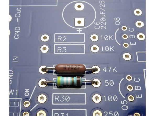 Numerical resistors, value facing up,  aligned with the F to the right.