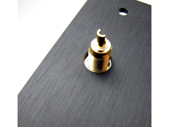 Second image: Again, viewing from the inside, the shoulder washer sits in the hole and keeps the metal of the RCA from touching the chassis