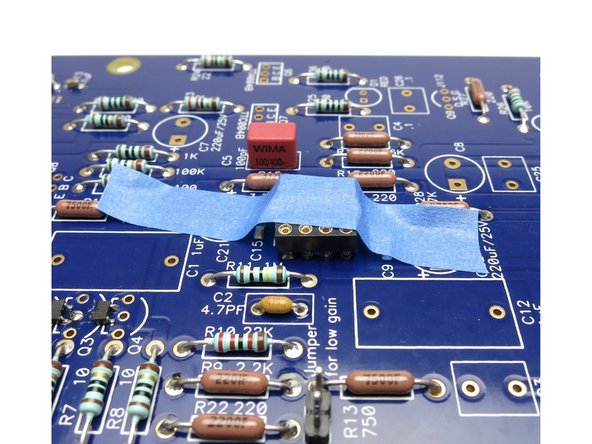 Use tape to hold socket in place, then solder the DIP socket.  See Photo 2