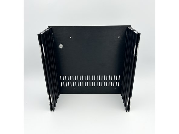 Fasten the bottom panel to the side rails using the black flat head screws included with your chassis.  Leave them just slightly loose.  Note - the side with two slots typically faces the interior of the chassis, but choose whatever you like aesthetically.