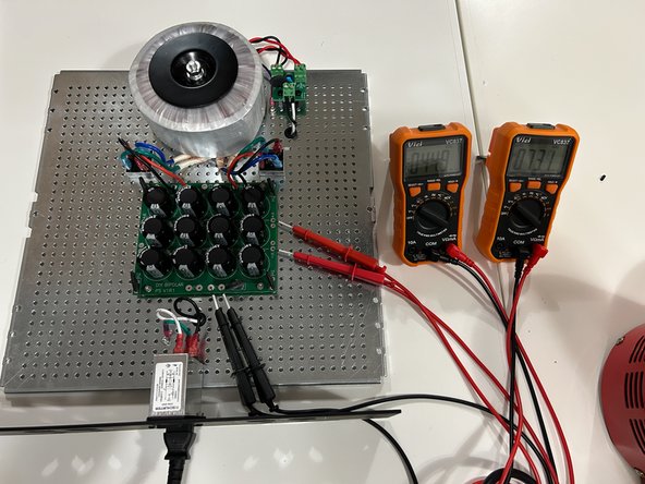 If you've disconnected any of your mains wiring for ease of assembly, connect your mains wiring to the PEM.  Place your perforated base plate / PSU assembly on a clean / neat / clutter free work space with a non-conductive surface.