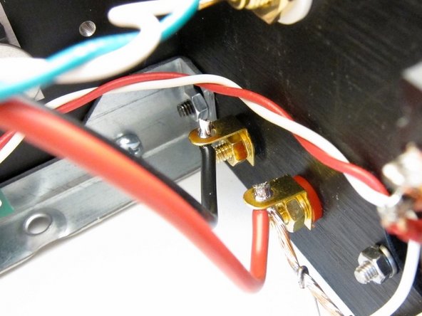 Third image: Now you may solder the ground buss to the speaker post.