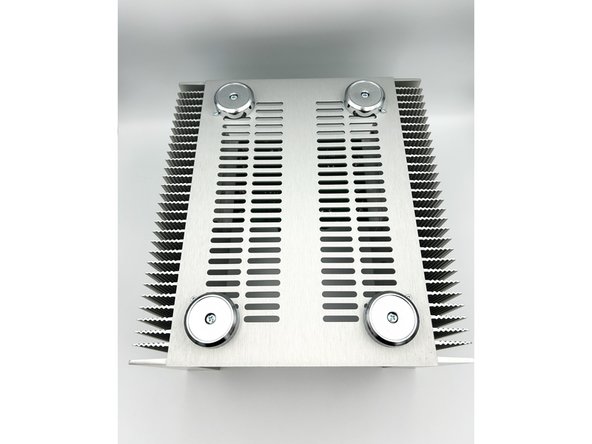 Temporarily install the bottom panel to the heatsinks with one or two screws.  Check to see which end of the panel has a ~3mm overhang past the edge of the heatsinks.  This side MUST go to the back of the chassis.    If it does not.  Turn the panel around.  The back of the chassis is the end away from the output stage.