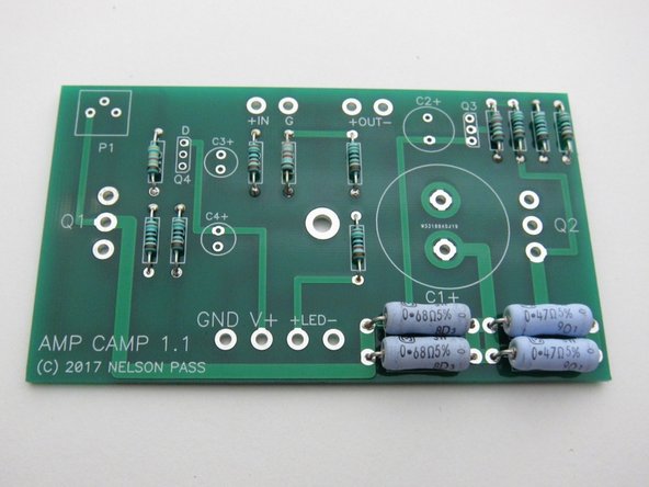 The big and little resistors in their places. Note the large resistors have the value printed right on them - try to bend the leads so the values show and align as shown.