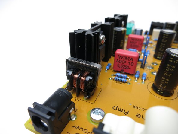 The common mode choke can go into the PCB either way – orientation doesn’t matter.  Put it in the PCB and solder. You don’t need to trim the leads.