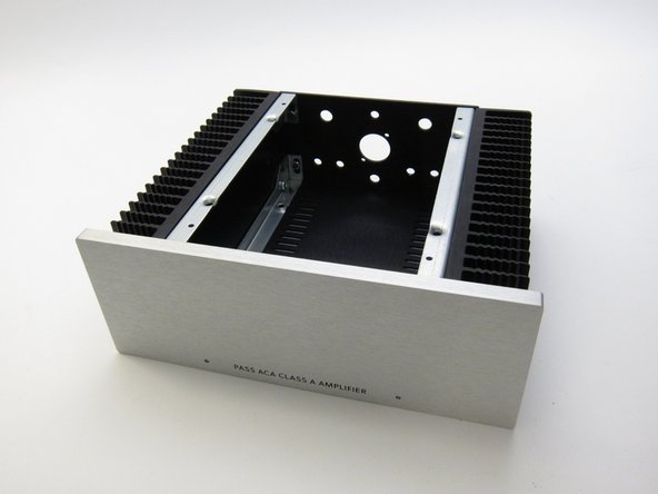 Sheet metal screws attach the top and bottom panels