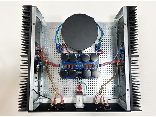Collect the heatsink / amplifier board assemblies. Mount the heatsinks to the perforated baseplate using the hardware provided with the chassis.