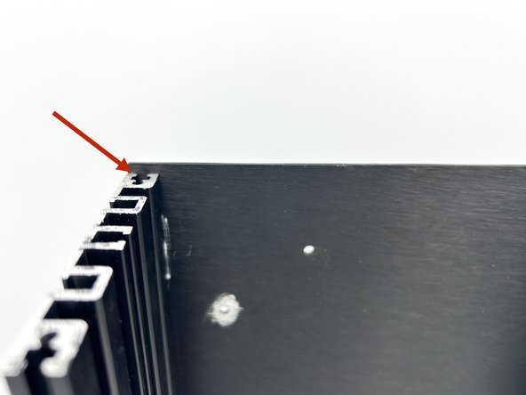 Set the side panels upright on a flat surface and allow the bottom panel to slide down leaving a slight gap at the 'top'.  Tighten the screws to the bottom panel. The bottom, top, left, right, front, and back of the chassis are now established.