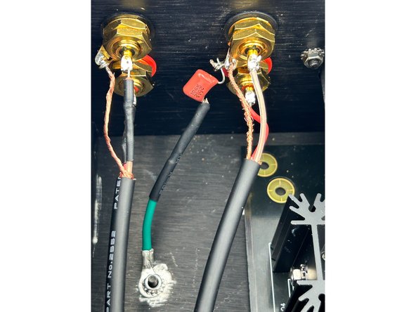 Install the RCA jacks and ground wire using the same method used for the pre-amp output wiring.  Slide the capacitor lead through one of the ground tabs and solder the assembly in place.