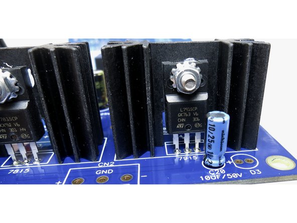 Solder regulators and heatsink legs to PCB.  Heatsink legs will require additional patience and/or a higher heat setting on your solder station.