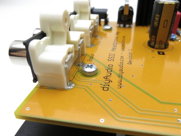 Note that the front edge  (with the potentiometer, switch and jack) of the PCB will be flush with the top plate.