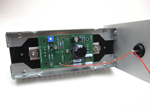 The bottom terminal receives power (V+) from the center pin of the barrel connector.