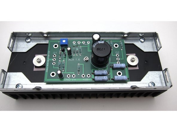 One screw and washer to hold the PCB to the center standoff, and align the big transistor legs with the holes.