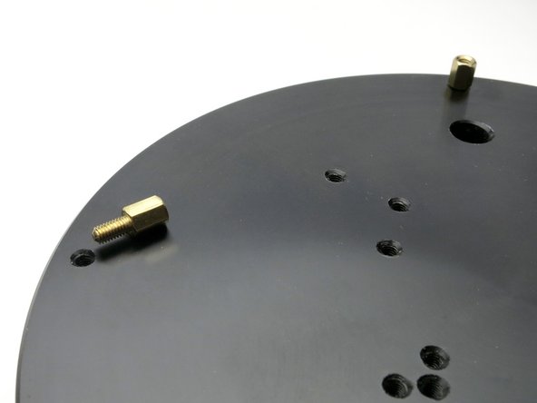 Screw the 4 brass standoffs into the outermost holes along the heatsink.